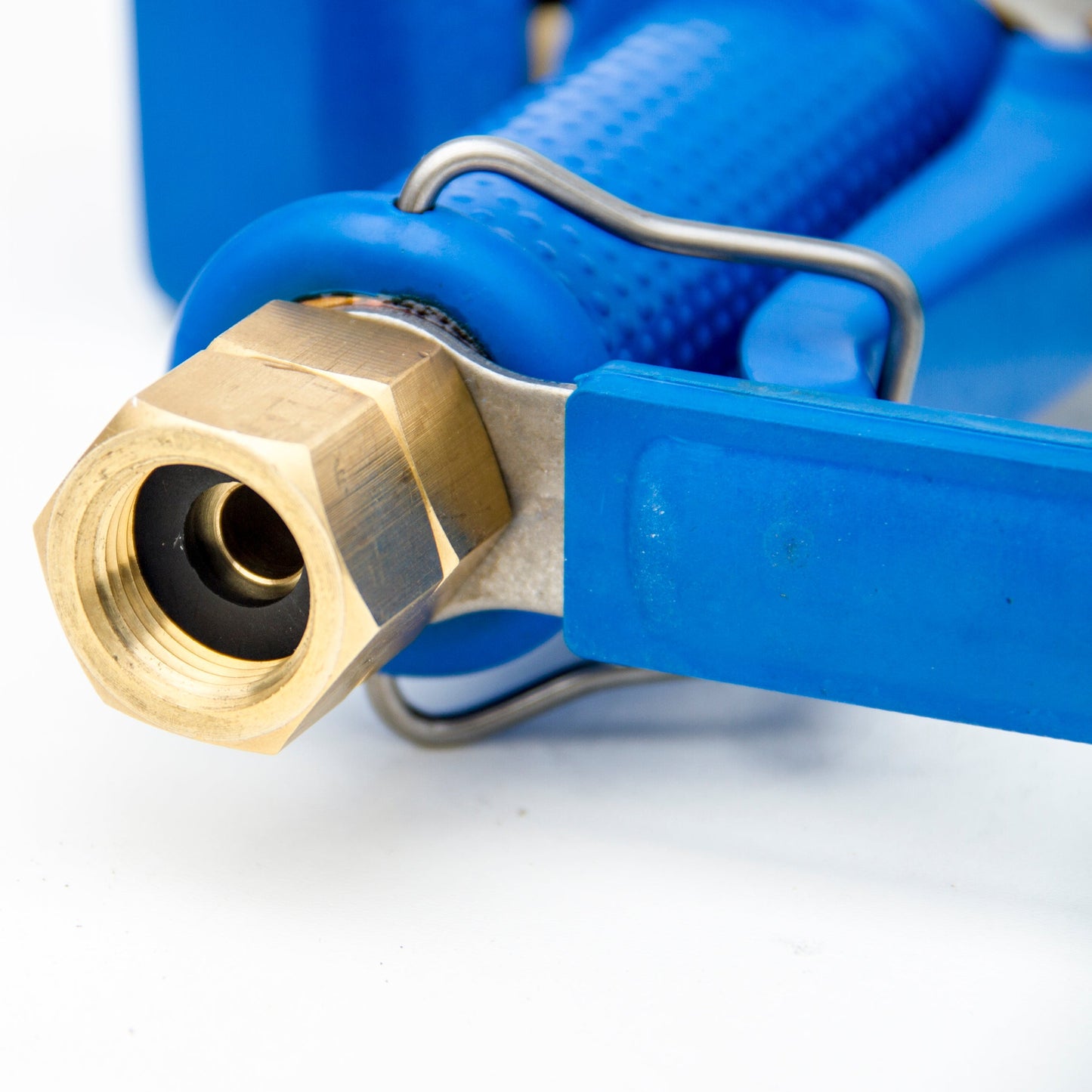 Close up of brass swivel inlet showing the BSP female thread. Fitted to a blue rubber coated brass water gun